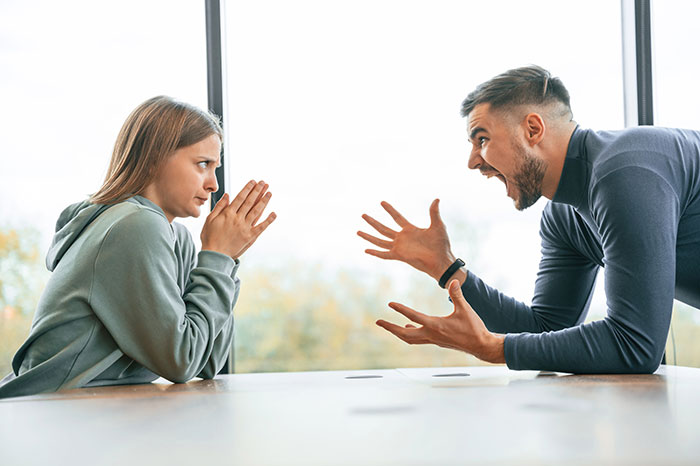 A man yells at a woman, symbolizing family conflict or domestic arguments in a son's house context.