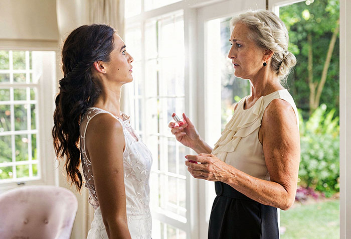 Bride and mother-in-law in tense conversation before wedding ceremony Bride and mother-in-law in tense conversation before wedding ceremony