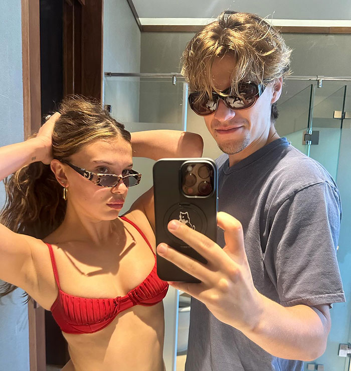 Millie Bobby Brown and Jake Bongiovi posing for selfie with sunglasses indoors Millie Bobby Brown and Jake Bongiovi posing for selfie with sunglasses indoors