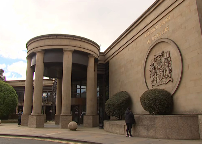 Exterior of Bracknell Magistrates court entrance with round pillars and emblem