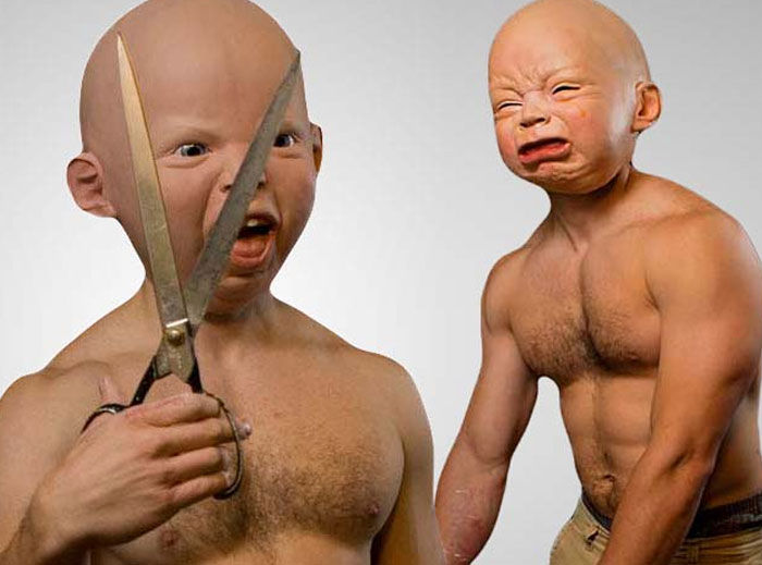 Disturbing safe for work image showing adult body with baby face holding scissors