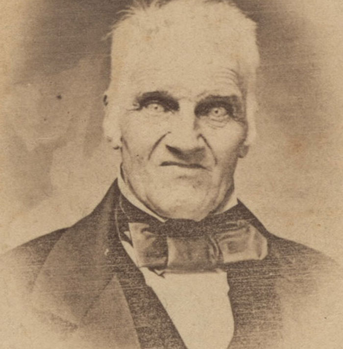 Antique portrait of man with intense stare and bow tie