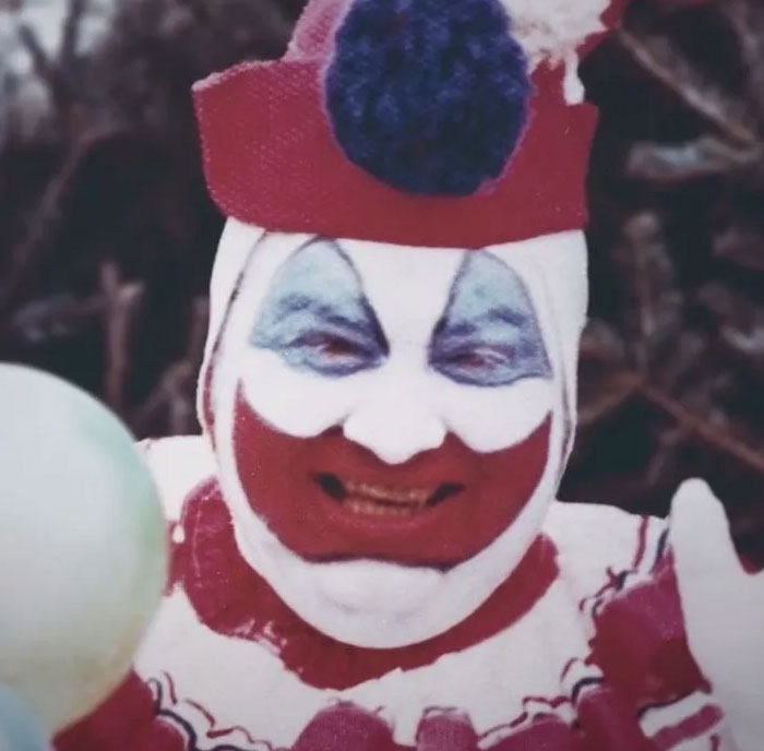 Creepy safe for work clown face with red and white makeup under hat