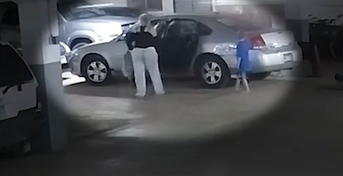 Security camera footage showing a woman and child near a car in a parking garage