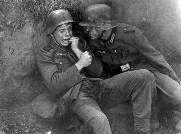 Black and white photo of two soldiers in emotional distress during war