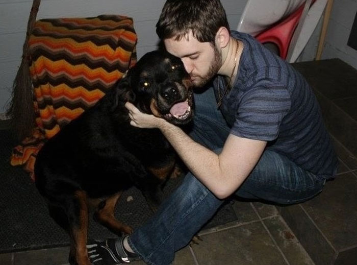 Man hugging and kissing a large dog showing a powerful emotional bond