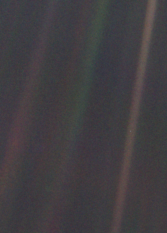 Powerful photo of Earth from space showing pale blue dot with sun rays