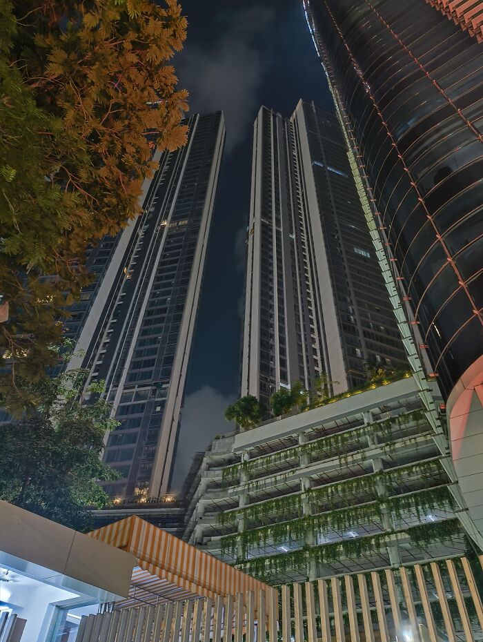 Night view of tall modern buildings with illuminated windows in incredible photo collection