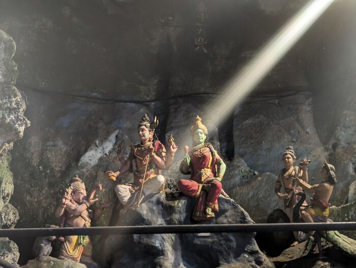 Random camera clicks show a mystical statue illuminated by an incredible ray of sunlight