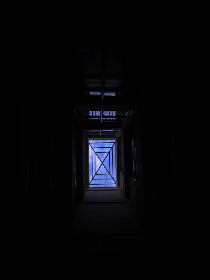 Random camera click through dark corridor with geometric ceiling and starry sky visible
