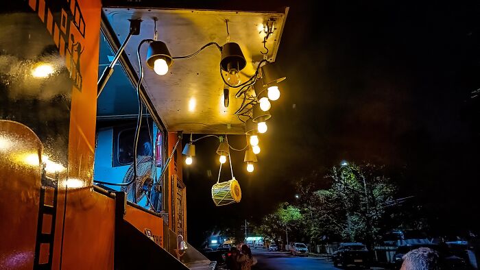 Night scene with lit storefront and hanging lights in random photo