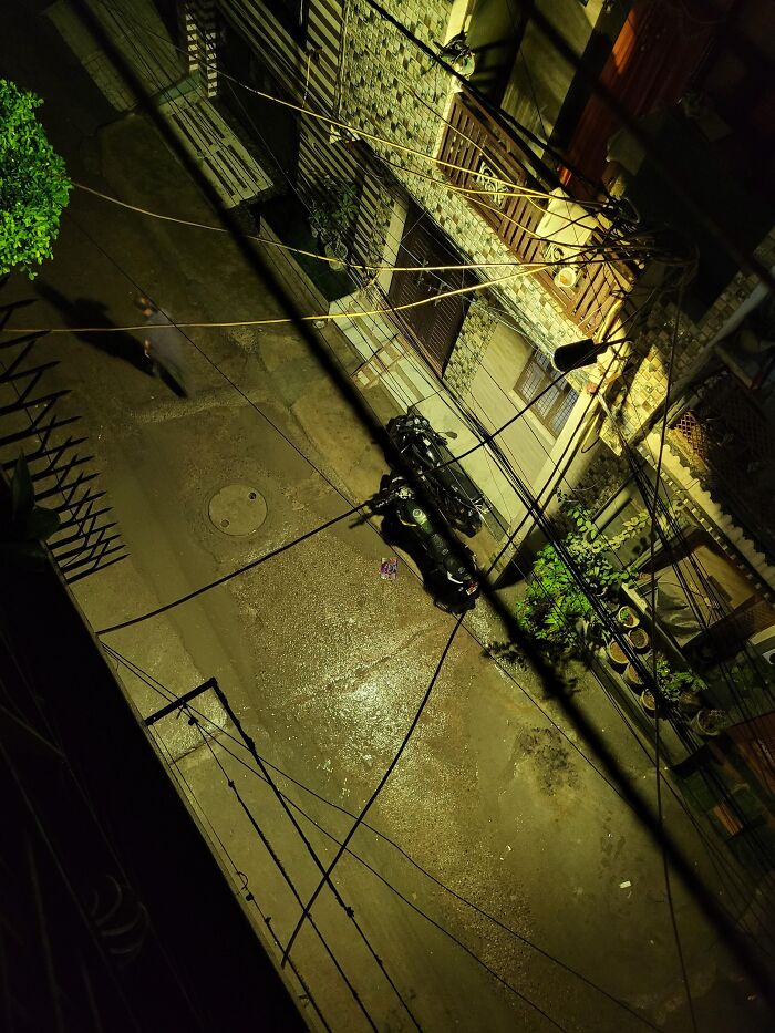 Night street scene with motorcycles and shadows in random camera click