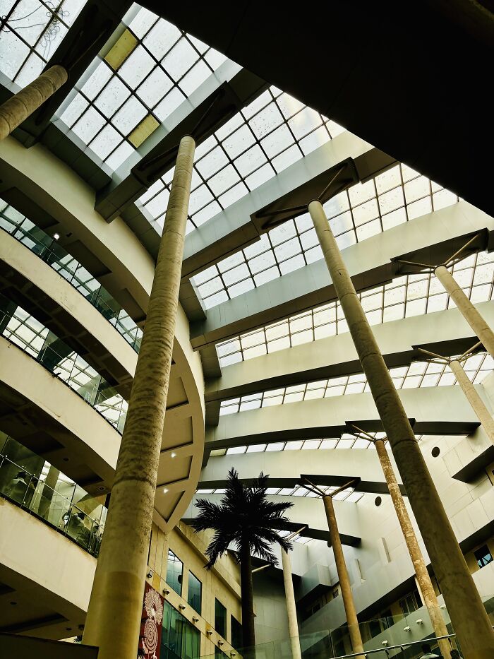 Modern building interior with tall columns and glass ceiling random camera clicks