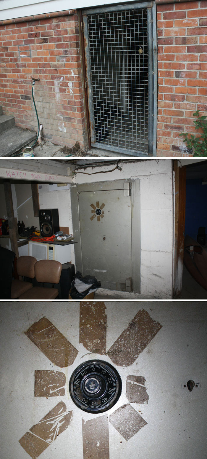 Metal barred door in brick wall with garden hose beside it