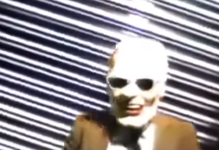 Unexplainable photo showing a mysterious figure wearing sunglasses against striped background