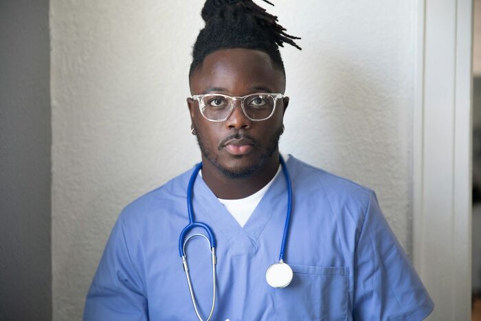 Male nurse wearing scrubs and stethoscope in psychiatric facility