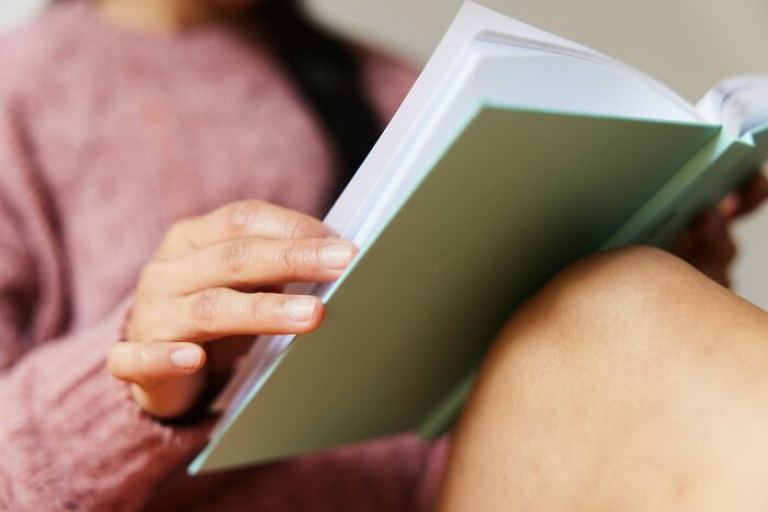 Close-up of person flipping pages of a book