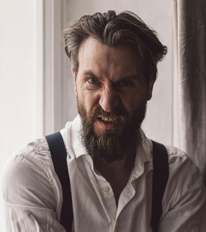 Angry bearded man representing conflict in toxic parents and will reading story