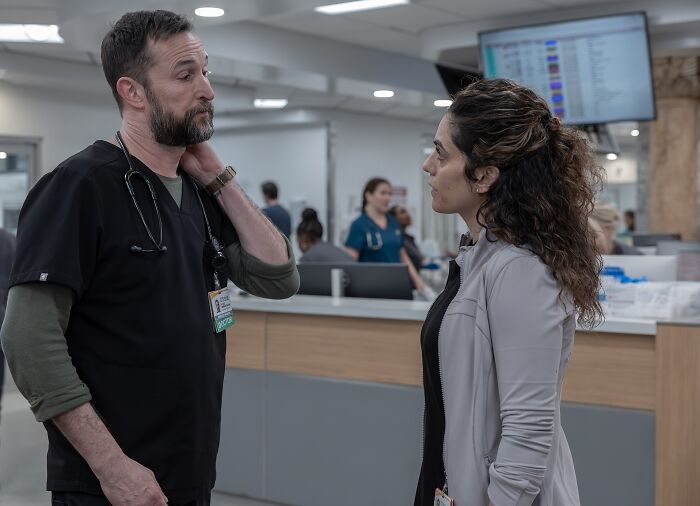 The Pitt star and Noah Wyle in hospital setting having a serious conversation The Pitt star and Noah Wyle in hospital setting having a serious conversation