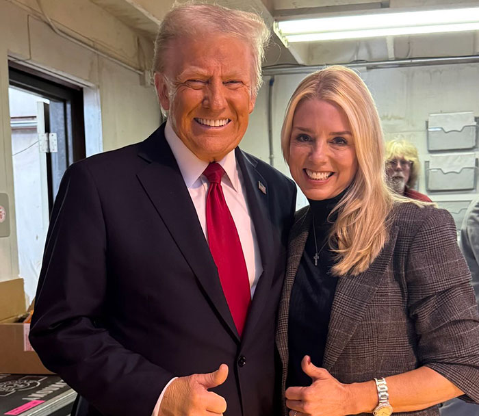Donald Trump and Pam Bondi smiling and posing together indoors
