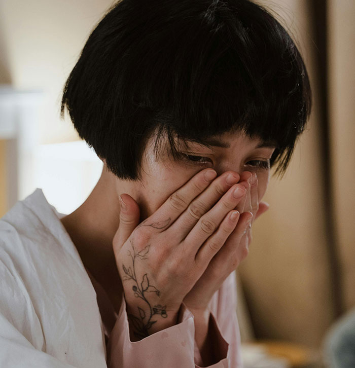 Woman crying upset covering mouth showing ugly cheating story emotions