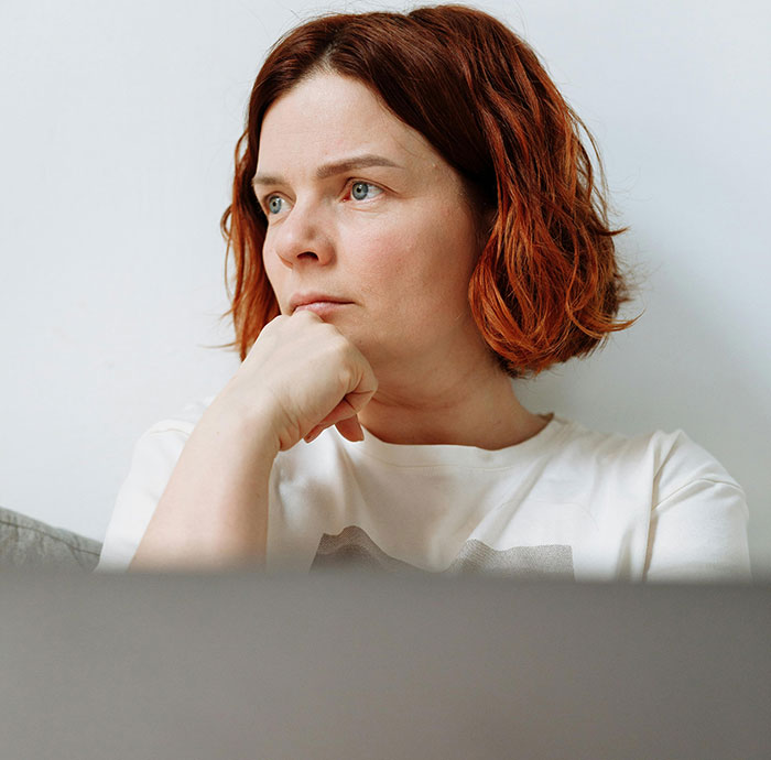 Pensive woman lost in thought relating to ugly cheating stories