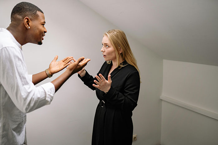 Couple arguing intensely indoors showing tension of cheating stories