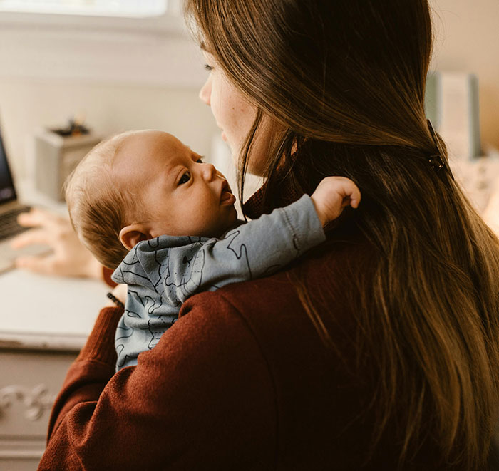 Mother holding baby looking concerned, related to cheating stories truths