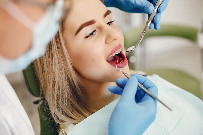 A young woman at a dental check-up with braces. Fun facts from professionals in dentistry.