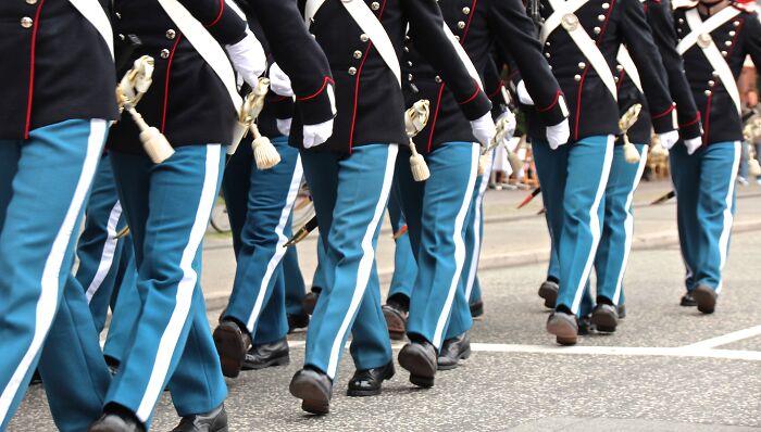 Soldiers in uniform marching, symbolizing discipline. A fun facts article could explore military traditions.