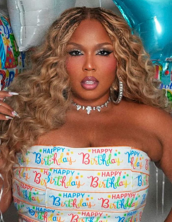 Lizzo wearing Happy Birthday top and diamond jewelry at celebration Lizzo wearing Happy Birthday top and diamond jewelry at celebration