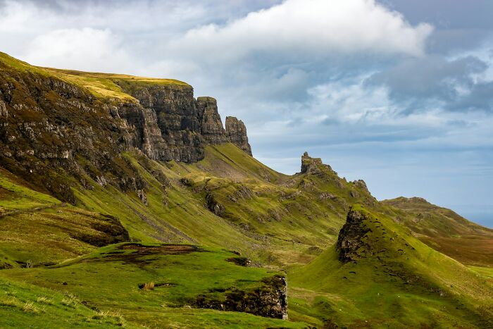 Scenic green hills and cliffs representing memorable random facts in nature