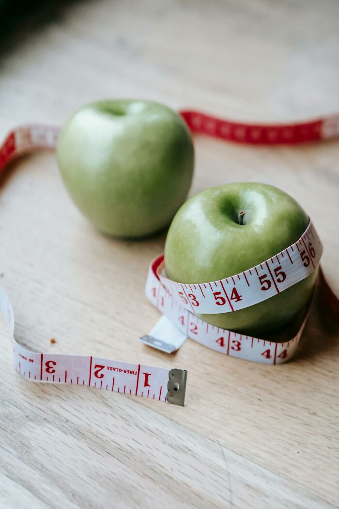 Green apples with measuring tape illustrating random facts about health