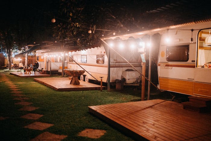 Night image of lit trailers with wooden decks Night image of lit trailers with wooden decks