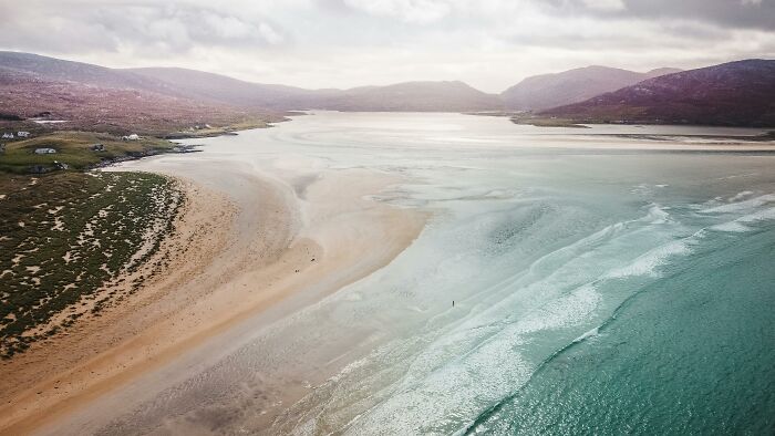 Aerial view of a coastal beach with stunning views and clear ocean waters