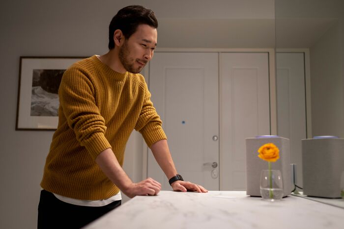 Man smiling in cozy sweater with laughing confessions theme