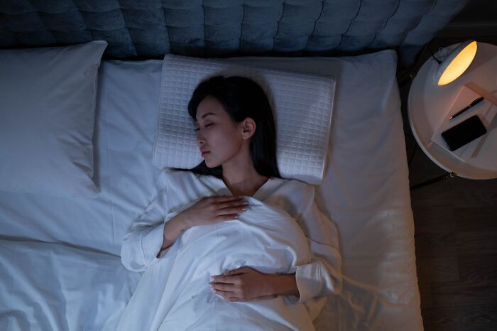Woman sleeping peacefully in bed at night