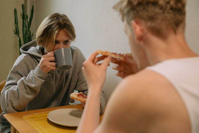 Couple sharing breakfast eating together in casual home setting