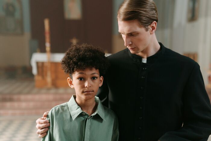 Supportive conversation between a priest and a young boy about cult escape