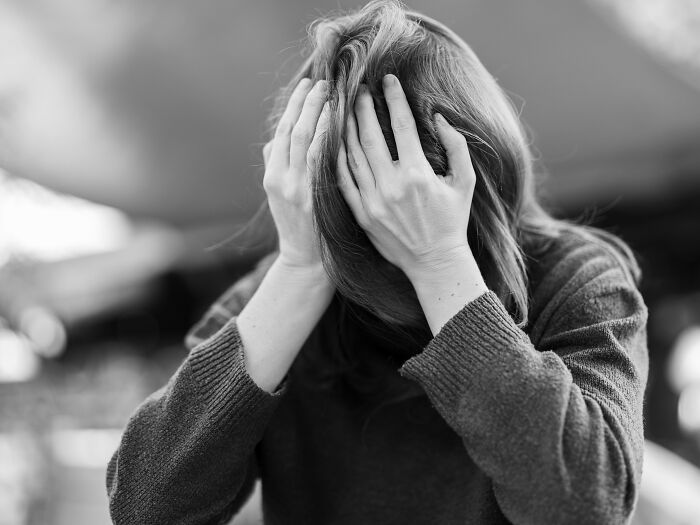 Girl in yellow hoodie with facial injuries and text on eye mutilation in creepy historical facts