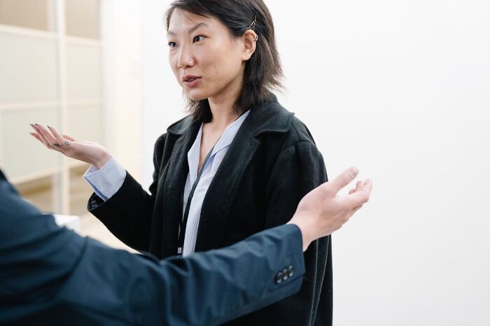 Woman gesturing explaining in conversation on boneheaded comments