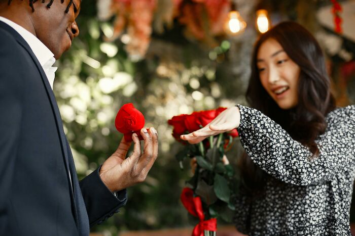 Man giving woman a rose illustrating unhinged exes romantic gestures