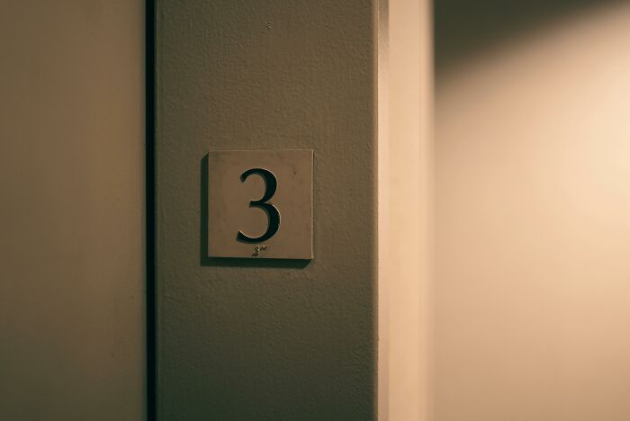 Door number three in dim light representing neighbors from hell apartment