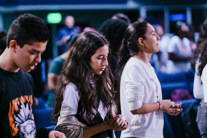 Young people in a religious gathering reflecting on escape from a cult experience