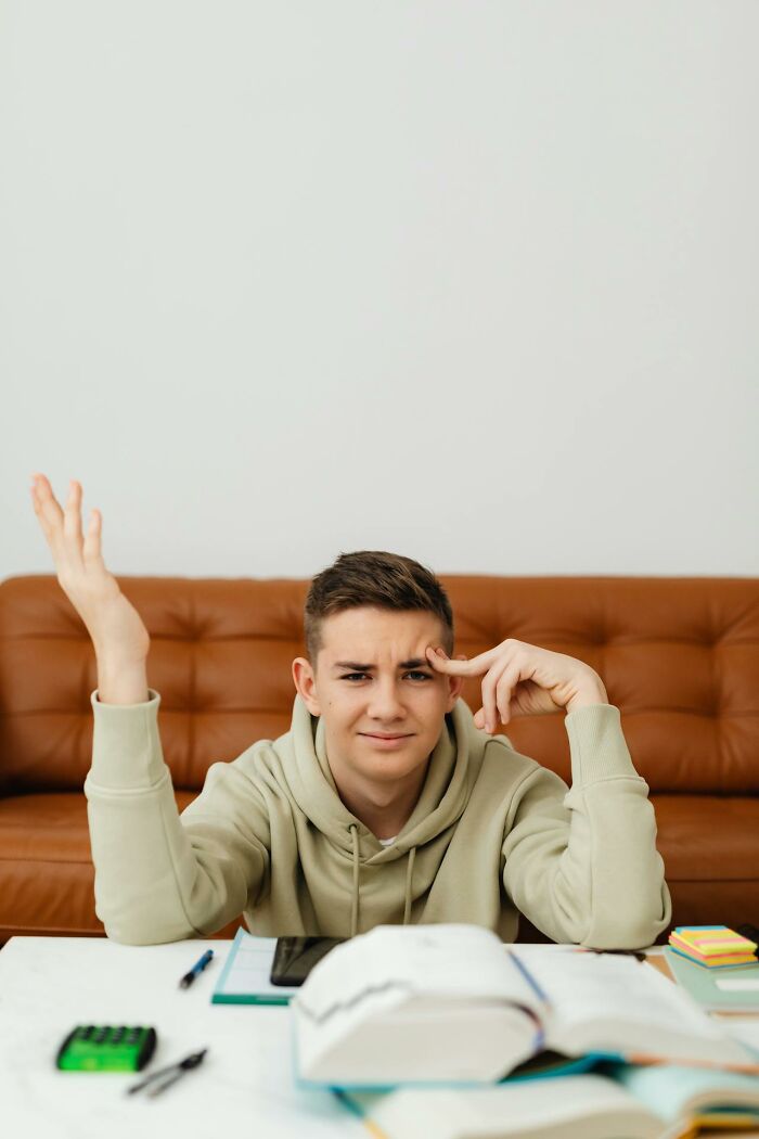 Teen confused studying with books in boneheaded comments theme
