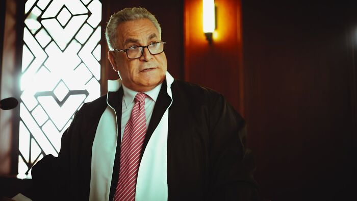 Judge in courtroom with serious expression about courtroom stories