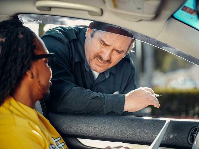 Police officer talking to driver about neighborhood disturbance issues