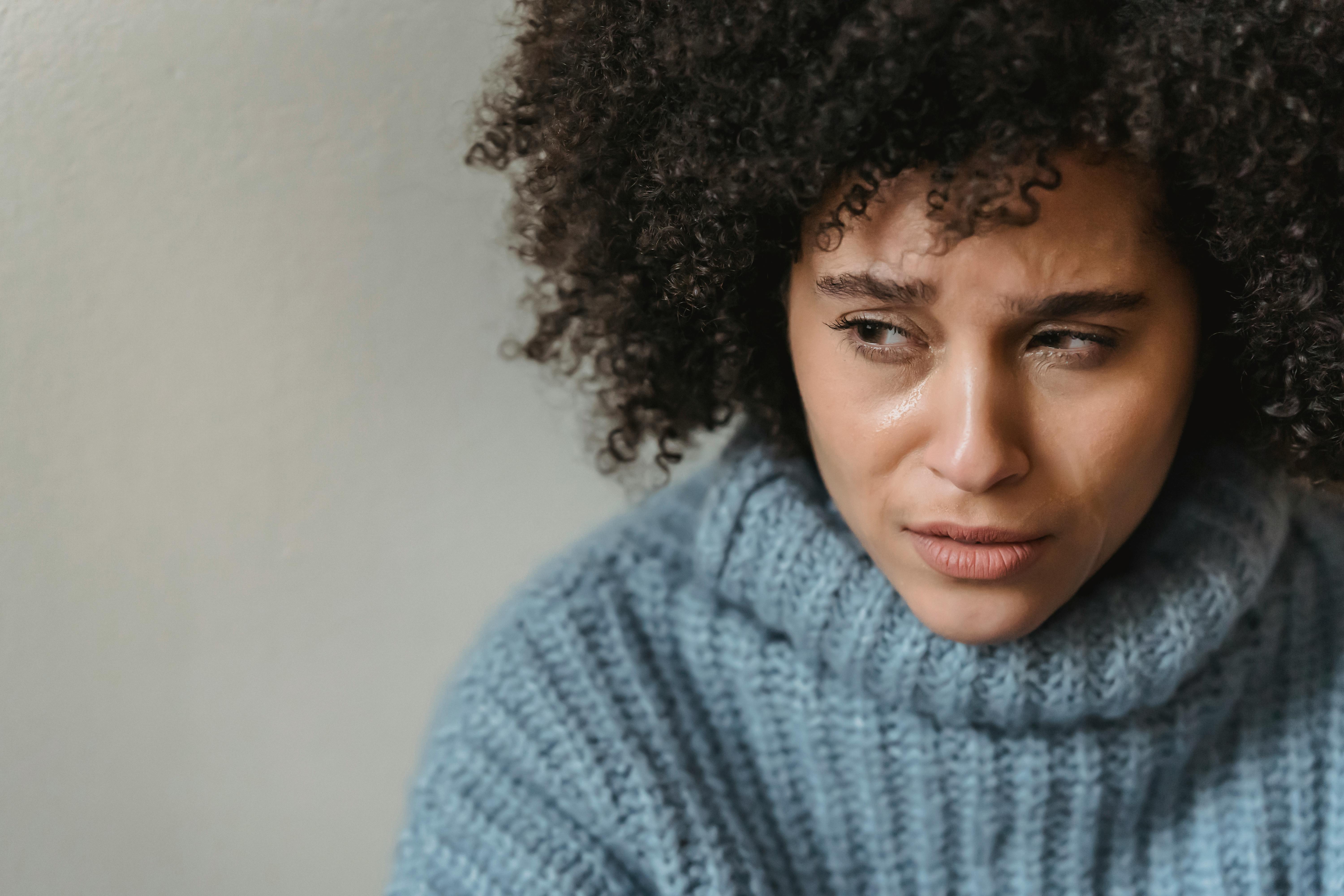 Woman looking distressed, reflecting emotional struggle in relationship with husband's friends