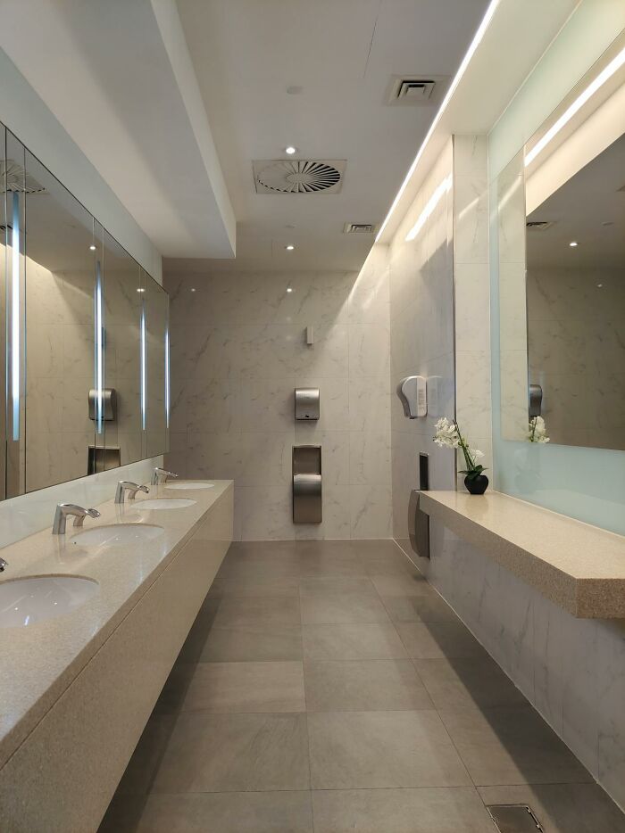 A clean, modern public restroom with multiple sinks and mirrors, illustrating a moment people experienced visiting the US.
