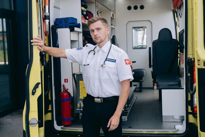 Paramedic standing in ambulance with courtroom stories context